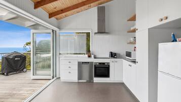 A modern kitchen with a built-in oven, dishwasher, and microwave.