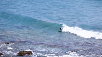 A surfer riding a wave in the ocean.