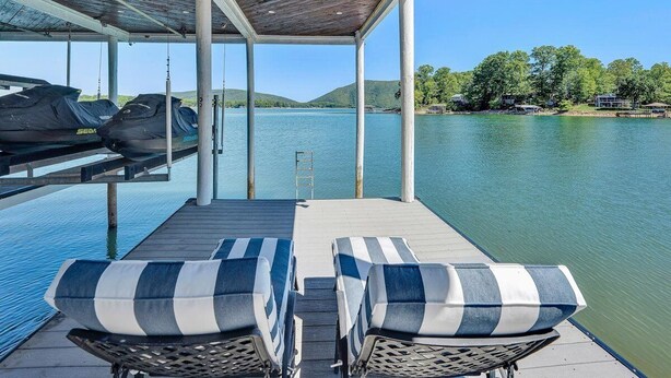 A covered deck with lounge chairs, a pool, and a view of a lake and hills. - Great Dock! Wifi, Propane Fire-Pit!  Come Visit "Dock Holiday"! (Huddleston)