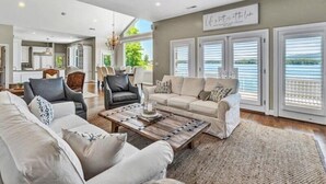 A spacious living room with a large ceiling fan, a fireplace, and a view of the outdoors. - Great Dock! Wifi, Propane Fire-Pit!  Come Visit "Dock Holiday"! (Huddleston)