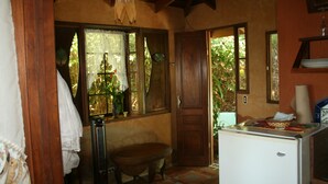 A compact kitchen with a refrigerator, a sink, and a window with curtains. - Montezuma Heights the cute Mariposa Cottage, into the great wide open.  Sleeps 2 (Montezuma)