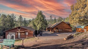 A rustic cabin-style building with a wooden exterior, a bench, and a clear sky. - Rainbow Trout Cabin quick drive to fishing lakes, backs forest, kitchen heat+AC (Payson)