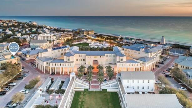 A large, multi-story building with a central courtyard, surrounded by smaller buildings and a beachfront. - Walk to Beach and Town Square w/ Gulf Views (Santa Rosa Beach)