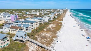 A coastal residential area with beachfront properties, a sandy beach, and a clear view of the ocean. - Walk to Beach and Town Square w/ Gulf Views (Santa Rosa Beach)