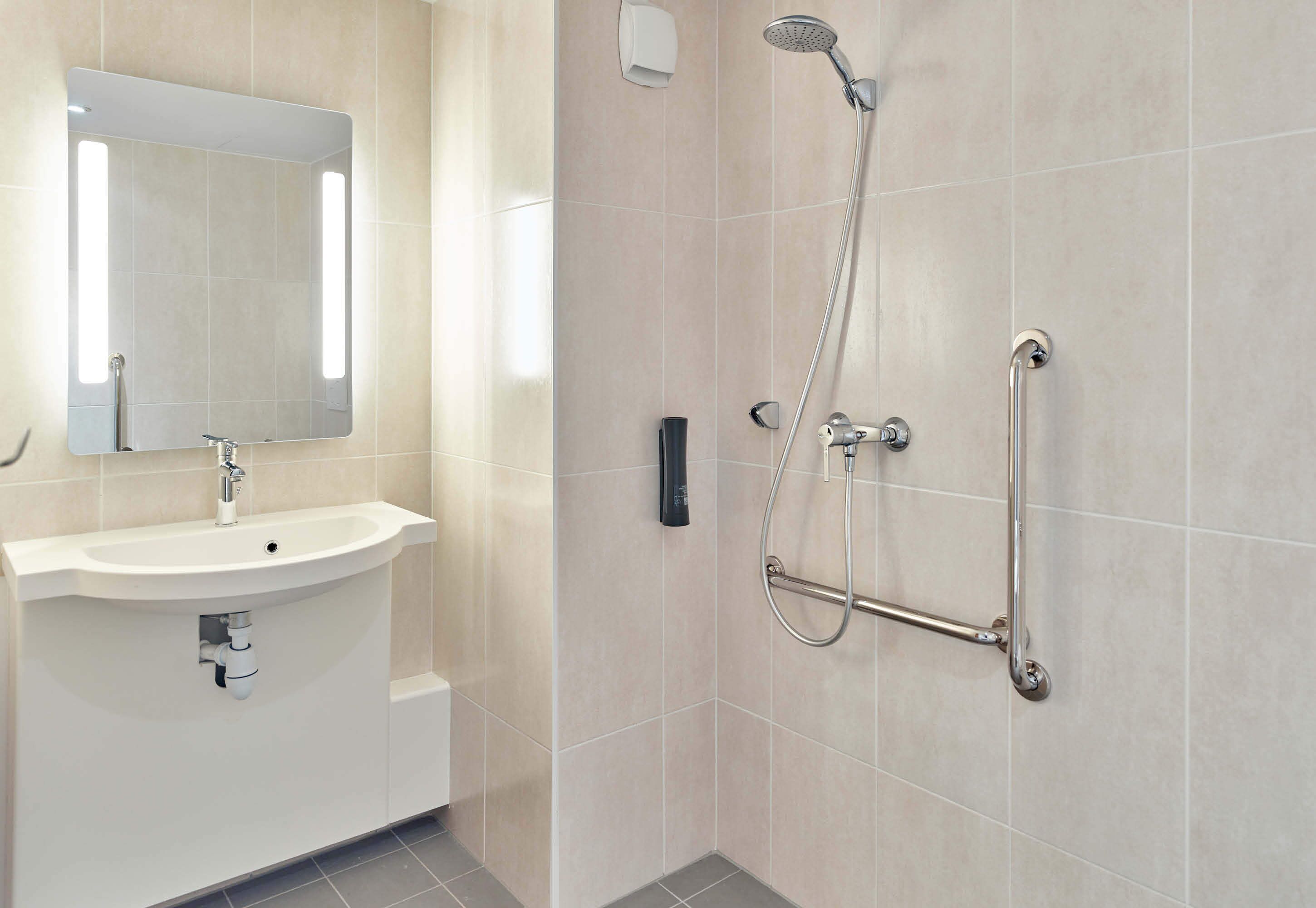 standard double room, mobility accessible | bathroom | shower, towels, soap, toilet paper