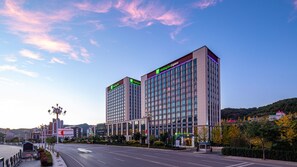 A modern hotel with a prominent Holiday Inn Express sign, large windows, and a clean urban street view. - Holiday Inn Express Chengde Park View by IHG (Chengde)