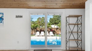 A room with a pool, a towel rack, and a metal shelf unit.