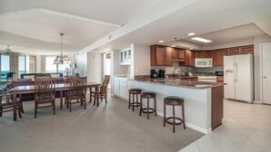 Una cocina amplia con una isla central, armarios de madera y electrodomésticos modernos.