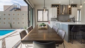 A modern kitchen with a central island, built-in cabinets, and pendant lighting. - Aquarius: Private Pool + Sand Dunes + Golf (Hurricane)