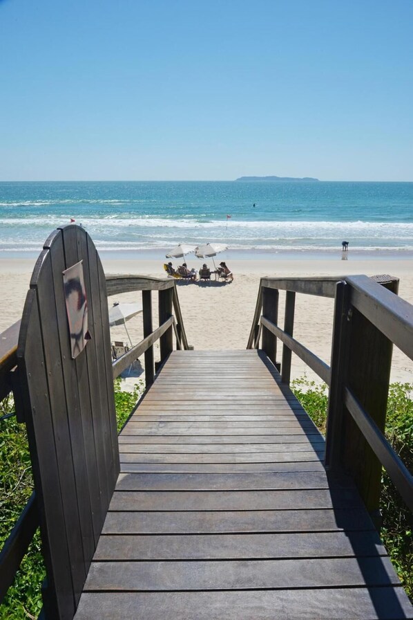 On the beach, white sand, sun loungers, beach umbrellas