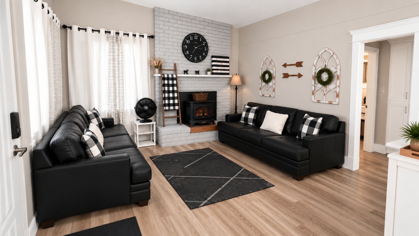 Bright farmhouse-style living room with cozy fireplace (decor only) and ample seating with wood grain porcelain tile floors