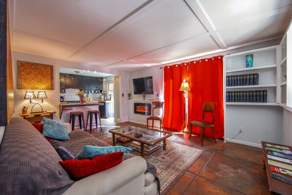 A living room with a sofa, coffee table, and bookshelves.