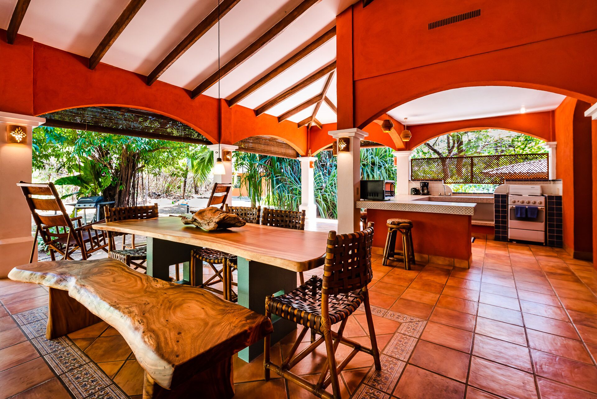 A spacious kitchen with a large island, bar stools, and a dining table.