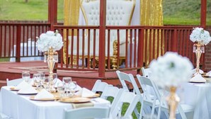 An outdoor wedding setup with white tables and chairs, a red gazebo, and a golden chair. - Ridge Creek Getaway, ideal 4 Friends&Family get-togethers, events & receptions.  (Brentwood)