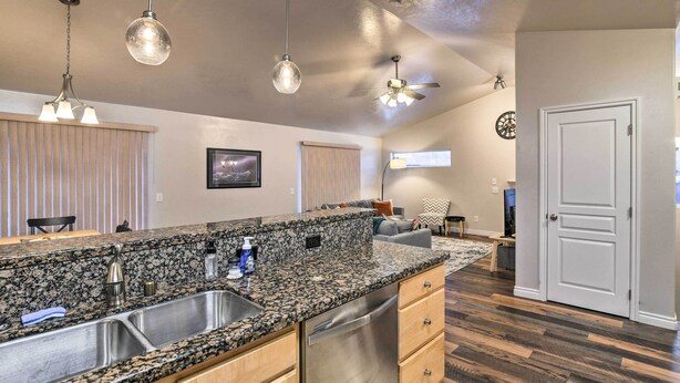 A kitchen with granite countertops, stainless steel appliances, and pendant lighting. - Cozy Anchorage Townhome < Half Mile to Jewel Lake! (Anchorage)