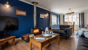 A cozy living room with a fireplace, a television, and comfortable seating.