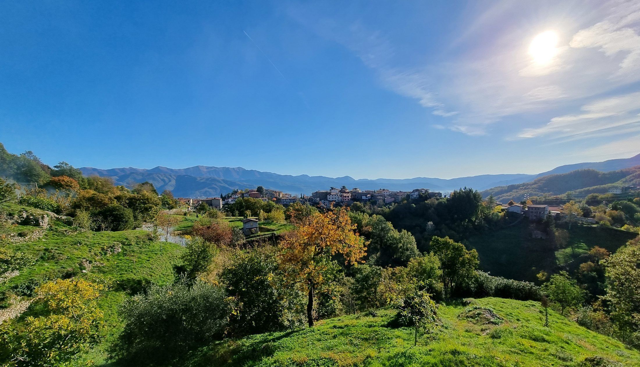 A mountainous landscape with a village nestled among the hills.