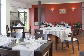 Enjoy a casual dining experience with tables set for a warm and inviting meal.