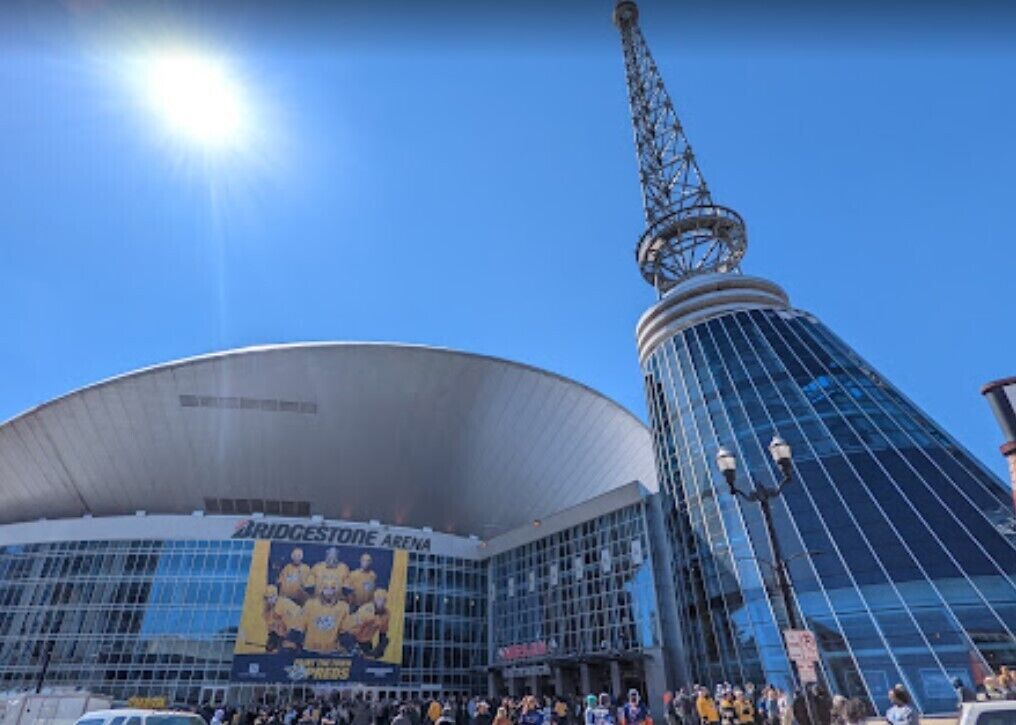 Bridgestone Arena with a large glass facade and a distinctive tower.