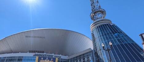 Bridgestone Arena with a large glass facade and a distinctive tower.