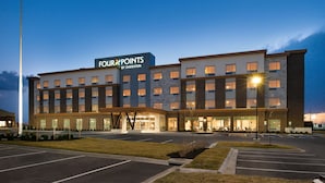 A multi-story hotel with a prominent sign reading "Four Points by Sheraton."