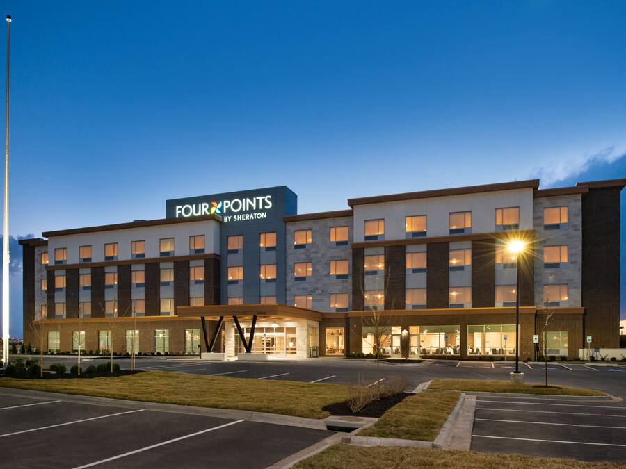 A multi-story hotel with a prominent sign reading "Four Points by Sheraton."