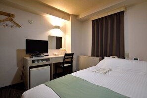 Enjoy a comfortable stay with a neatly made bed, flat-screen TV, and convenient amenities.