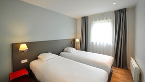 A hotel room with two beds, a red nightstand, and a window with curtains. - Villa for 6 people 300m from the beaches for 6 people (La Palmyre)