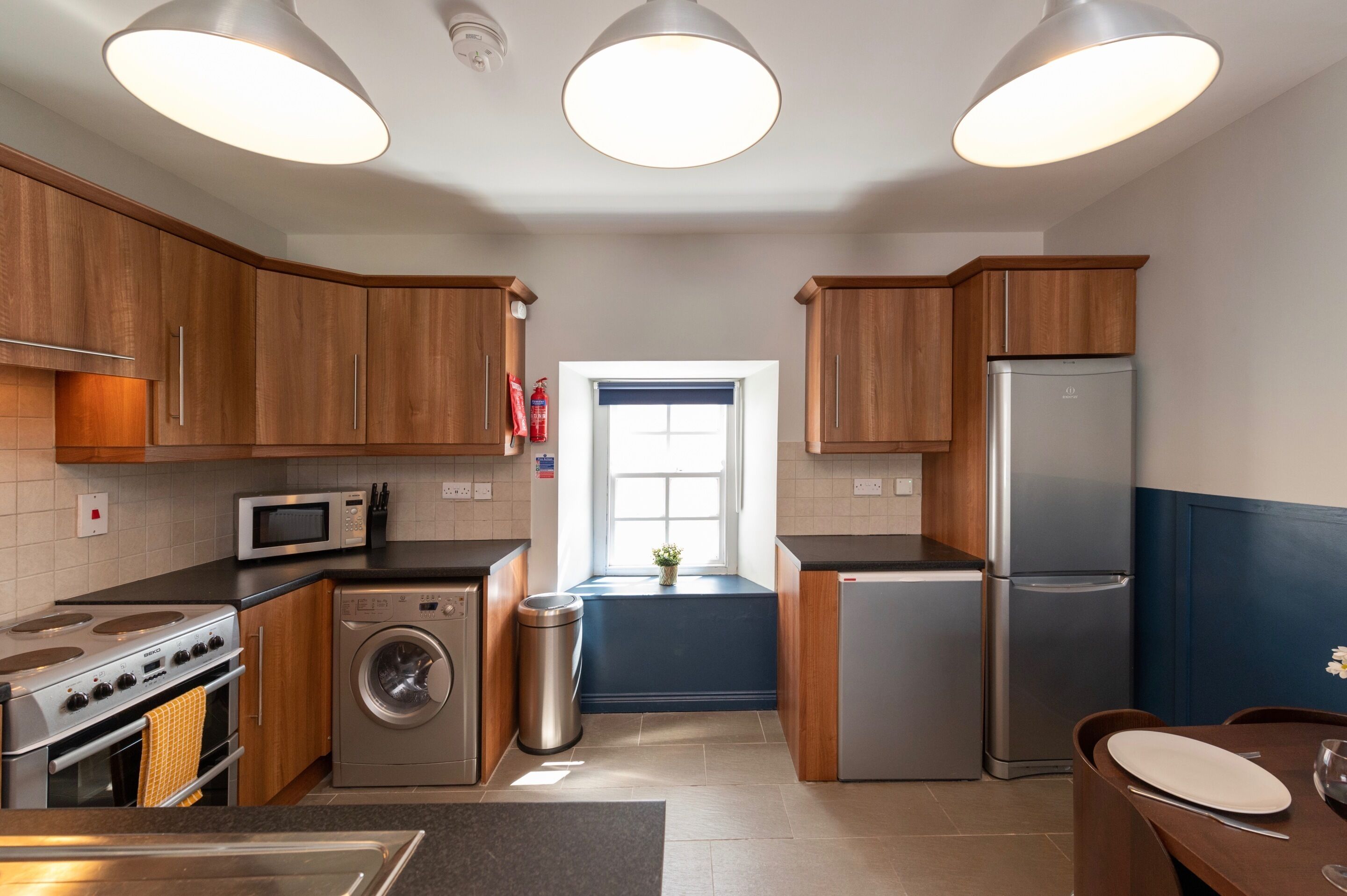 Fully fitted kitchen with plenty of appliances .