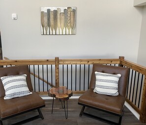 Relax in a comfortable seating area with two armchairs and a small table.