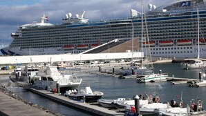 A large cruise ship docked at a marina with multiple smaller boats and yachts nearby. - Atlantic House (Ponta Delgada)