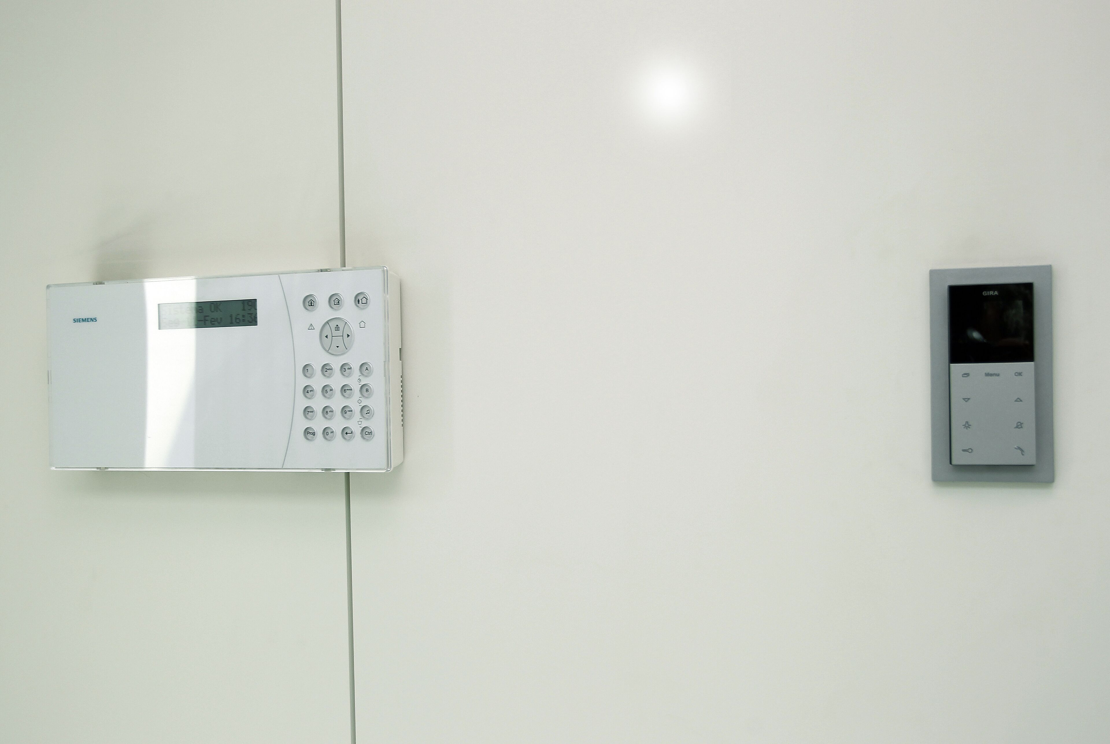 A wall-mounted control panel with a digital display and several buttons.