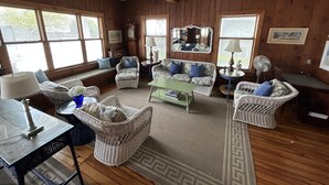 A cozy living room with wicker furniture, a coffee table, and a fireplace. - 7br/3.5ba Classic Bay Head Beach House Steps To The Beach  (Bay Head)