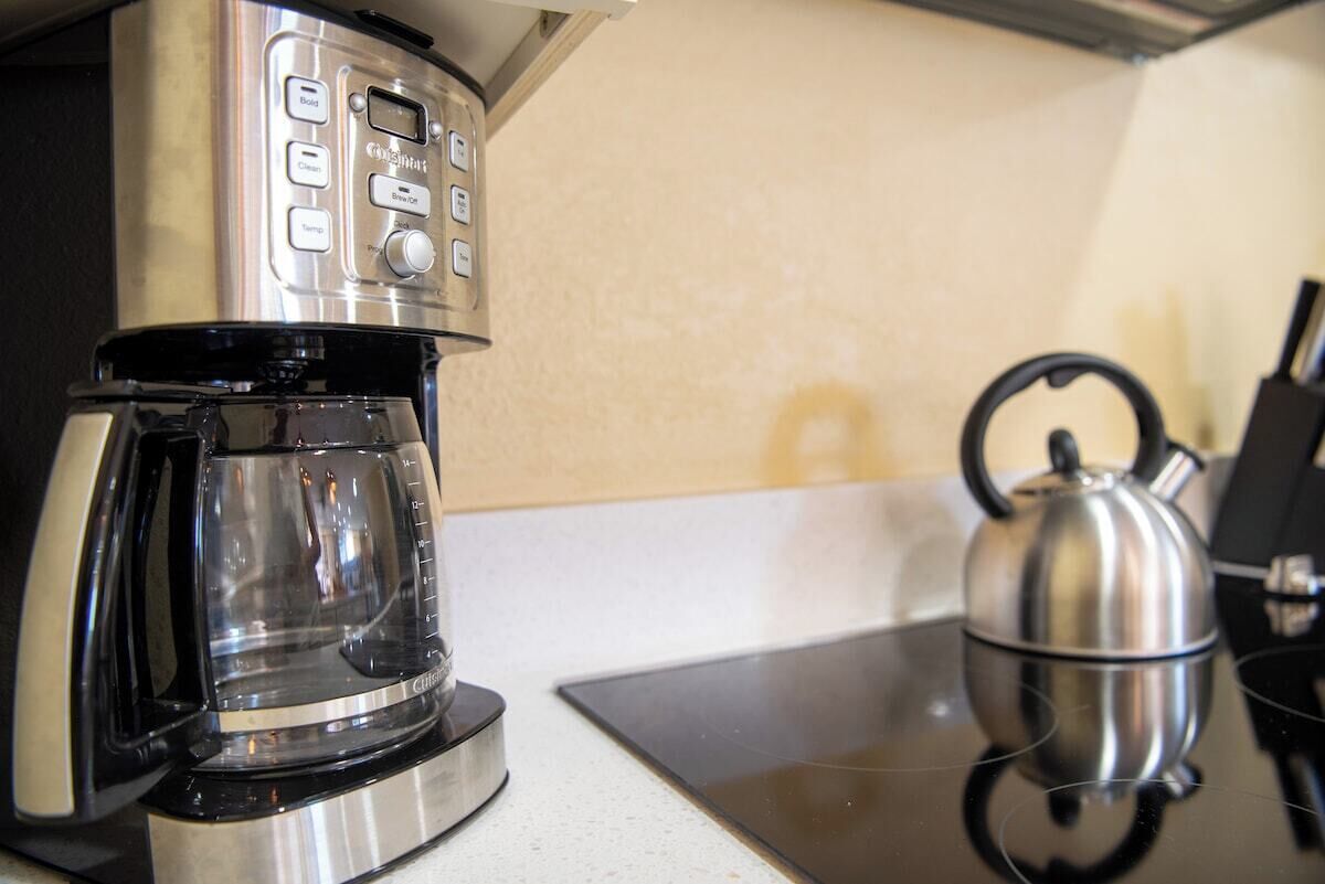 A coffee maker with a digital interface on a kitchen counter.