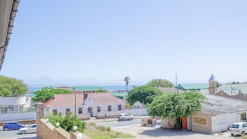 A coastal town with buildings, a street, and a view of the sea.