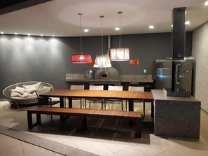 Enjoy cooking in the kitchen with a pizza oven and stainless steel range hood.