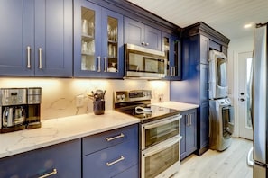 Enjoy cooking in this well-equipped kitchen with a microwave, oven, and refrigerator.