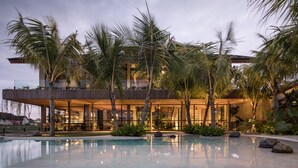 A modern resort with a pool, palm trees, and a covered outdoor area. - Exceptional Architect's 5BR Villa, an Oasis Gem in Canggu Centre (Canggu)
