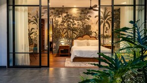 A bedroom with a large bed, a nightstand, a lamp, and a ceiling fan. - Contemporary Private Villa, 4 BR, Canggu With Staff (Canggu)