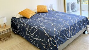 A bedroom with a bed, two pillows, a bedside table with a lamp, and three framed pictures on the wall. - Pierre Longue,3 bedrooms apartment with sea view in bulding with swimming pool (Cannes)