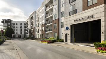 A multi-story parking garage with a clear entrance and a sign indicating parking availability.