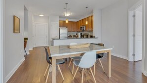 Une cuisine moderne avec des meubles en bois, un îlot central et des luminaires suspendus.