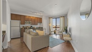 A modern apartment with a kitchen, living area, and dining space.