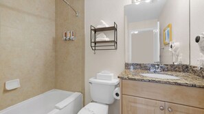 A bathroom with a bathtub, toilet, sink, and a towel rack.