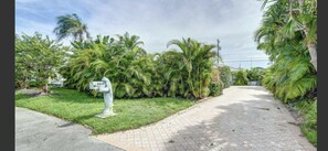 Set amidst lush greenery, this home offers a serene retreat with a front yard.