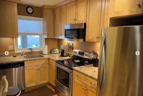 Enjoy cooking in this well-equipped kitchen with a dishwasher, stove, oven, microwave, and refrigerator.