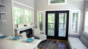 A compact living space with a dining area, a sofa, and a fireplace. - Riverfront Home I Kayak & Fishing I 6 mins Mentone (Mentone)