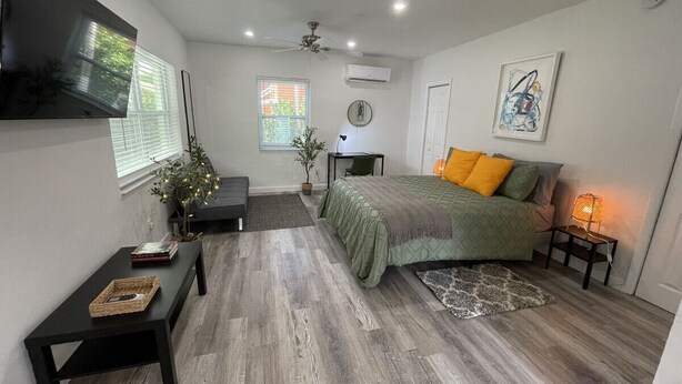 A modern bedroom with a bed, bedside table, and a small desk with a chair. - 526 · Beautiful and Spacious studio - Casa Habana (Little Habana)