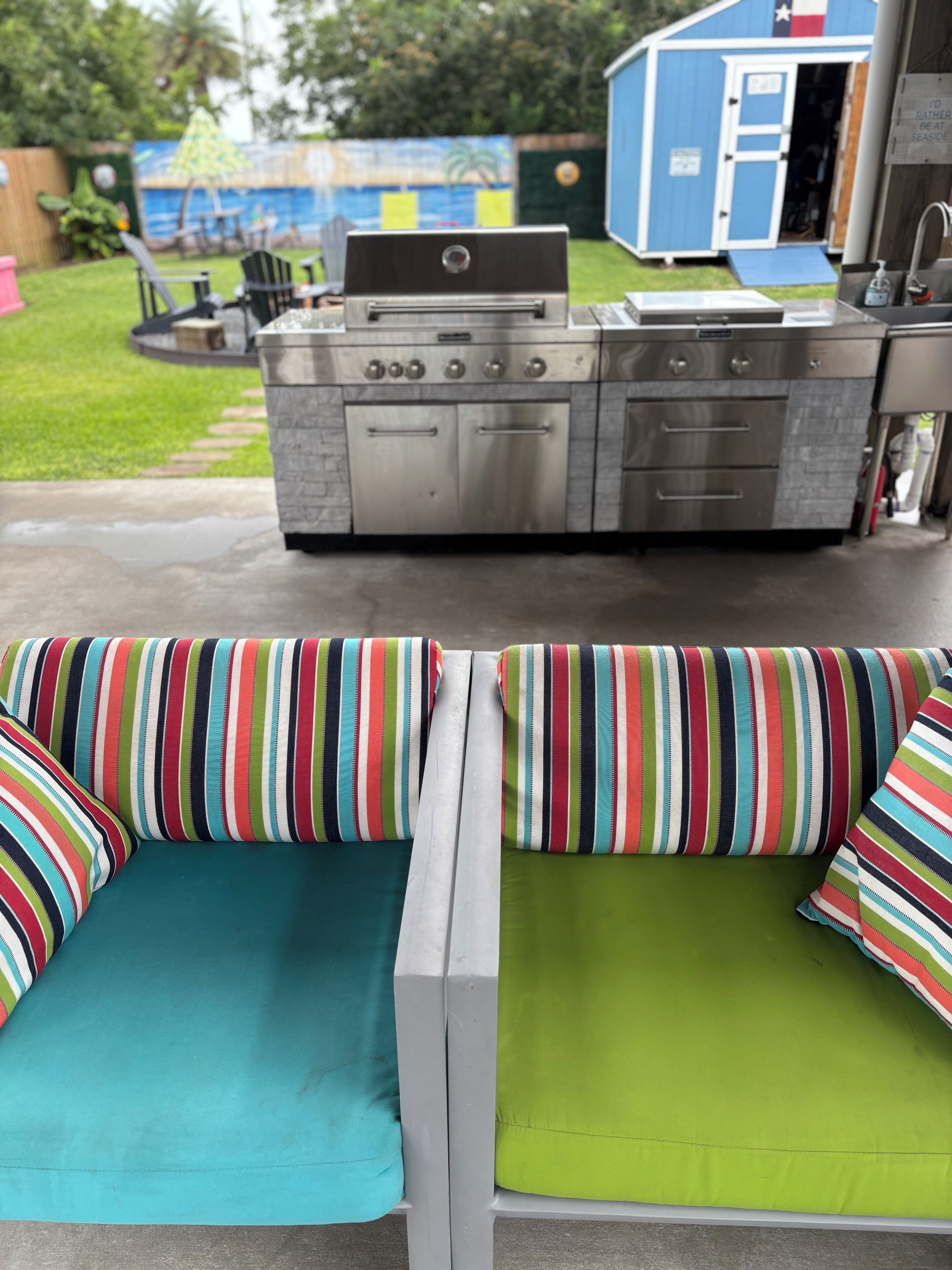 A patio with a grill and outdoor seating.