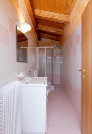 Bathroom features a sink, toilet, and shower enclosure.